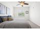 This bedroom features a ceiling fan, natural light and neutral walls and carpet at 4451 S Ammons St # 4-203, Littleton, CO 80123