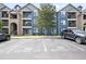 Apartment complex view with parking spaces and convenient building accessibility at 4451 S Ammons St # 4-203, Littleton, CO 80123