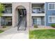 Exterior view of the building with stairwell access to upper-level units and balcony views at 4451 S Ammons St # 4-203, Littleton, CO 80123
