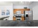 Kitchen featuring stainless steel appliances, oak cabinets and a black countertop at 4451 S Ammons St # 4-203, Littleton, CO 80123