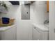 A laundry room with a washer, dryer, and shelves at 4451 S Ammons St # 4-203, Littleton, CO 80123