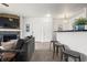 Inviting living area with a fireplace, mounted TV, bar stools, and an open kitchen at 4451 S Ammons St # 4-203, Littleton, CO 80123