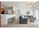 Spacious living room featuring modern furnishings and an open layout flowing into the kitchen area at 4451 S Ammons St # 4-203, Littleton, CO 80123