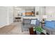 Living area showing a sofa, open to dining area and kitchen with counter seating at 4451 S Ammons St # 4-203, Littleton, CO 80123