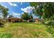 Large backyard showcasing a detached garage, brick grill, and a lush green lawn at 10841 Montview Blvd, Aurora, CO 80010