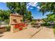 Backyard with a built-in brick grill and picnic table set, perfect for outdoor entertaining at 10841 Montview Blvd, Aurora, CO 80010