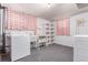 Basement featuring a laundry area with a washing machine, sink, and storage shelves at 10841 Montview Blvd, Aurora, CO 80010