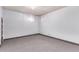 Spacious basement with a clean and minimal design, and carpeted floors for added comfort at 10841 Montview Blvd, Aurora, CO 80010
