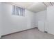 Basement with a neutral color scheme, window with curtains, and a built-in cabinet space for storage at 10841 Montview Blvd, Aurora, CO 80010
