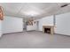 Large basement featuring neutral walls, a brick fireplace, and carpeted floors at 10841 Montview Blvd, Aurora, CO 80010