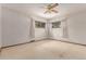 Empty bedroom with neutral walls, carpeted floors, and natural light from two windows at 10841 Montview Blvd, Aurora, CO 80010