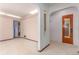Open hallway featuring arched doorways and a glimpse into other rooms at 10841 Montview Blvd, Aurora, CO 80010