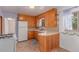 Well-lit kitchen with wooden cabinetry, a corner sink, and ample counter space at 10841 Montview Blvd, Aurora, CO 80010