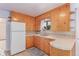 Cozy kitchen with wooden cabinets, a practical layout, and a window above the sink at 10841 Montview Blvd, Aurora, CO 80010