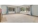 Bright living room featuring large windows, neutral paint, and a brick fireplace at 10841 Montview Blvd, Aurora, CO 80010