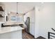 Modern kitchen featuring stainless steel appliances, white cabinetry, and a breakfast bar at 1051 Chase St, Lakewood, CO 80214