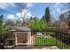 Backyard view features a hot tub, outdoor seating, lush greenery, and an outdoor fireplace at 350 Albion St, Denver, CO 80220