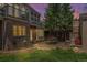 Backyard patio with stone pavers, a built-in grill area, outdoor seating, and lush greenery at 350 Albion St, Denver, CO 80220