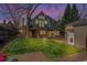 Exterior shot of the home with a lush lawn, patio area, and charming architectural details at twilight at 350 Albion St, Denver, CO 80220