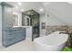 Luxurious bathroom featuring a soaking tub, modern vanity, and a glass-enclosed shower at 350 Albion St, Denver, CO 80220
