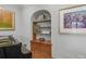 Built-in shelves create a cozy nook near the living room and grand piano at 350 Albion St, Denver, CO 80220