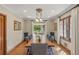 Bright dining room with long wooden table, stylish chairs, and French doors to the backyard at 350 Albion St, Denver, CO 80220
