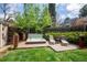 Relaxing hot tub with lounge chairs on a wooden deck surrounded by lush greenery and planters at 350 Albion St, Denver, CO 80220