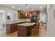 Kitchen with granite countertops, center island with breakfast bar, and wood cabinets at 350 Albion St, Denver, CO 80220