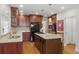 Kitchen with granite countertops, center island with cooktop and breakfast bar, and wood cabinets at 350 Albion St, Denver, CO 80220