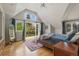 Bright main bedroom with vaulted ceiling, hardwood floors, and access to a private balcony at 350 Albion St, Denver, CO 80220