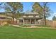 Spacious yard with mature trees and covered patio perfect for enjoying outdoor living at 7882 S Valentia Way, Centennial, CO 80112