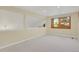 Finished basement space with neutral carpet and a window at 7882 S Valentia Way, Centennial, CO 80112