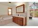 Bathroom with double vanity, tub, and large windows at 7882 S Valentia Way, Centennial, CO 80112