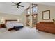 Bright Primary bedroom with vaulted ceilings, large windows, and wooden furniture at 7882 S Valentia Way, Centennial, CO 80112