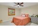 Bedroom features a queen-sized bed and a wooden window at 7882 S Valentia Way, Centennial, CO 80112