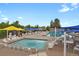 Community pool area with ample seating, umbrellas, and lounge chairs at 7882 S Valentia Way, Centennial, CO 80112