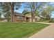 Inviting front exterior view of the home, displaying the lawn, brick and siding at 7882 S Valentia Way, Centennial, CO 80112