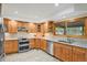 Well-equipped kitchen with custom cabinets, modern appliances, and granite countertops at 7882 S Valentia Way, Centennial, CO 80112
