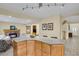Open kitchen with island seating and granite countertops, next to the living room at 7882 S Valentia Way, Centennial, CO 80112