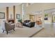 Open-concept living room with a cozy fireplace, vaulted ceilings, and stylish furnishings at 7882 S Valentia Way, Centennial, CO 80112
