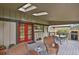 Covered outdoor patio with skylights has wicker furniture, ceiling fan, table, and gas grill at 7882 S Valentia Way, Centennial, CO 80112