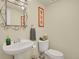 Charming powder room featuring a pedestal sink, framed mirror, and neutral tones at 7882 S Valentia Way, Centennial, CO 80112