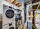 Functional basement area with washer, dryer, shelving, and utility equipment at 1103 S Monaco Pkwy, Denver, CO 80224