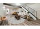 Finished basement with a cozy sitting area, stylish decor, and easy access to the staircase, perfect for relaxation and entertainment at 1103 S Monaco Pkwy, Denver, CO 80224