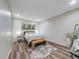 Bright bedroom with a cozy bed, complemented by a woven bench, creating a comfortable and inviting personal space at 1103 S Monaco Pkwy, Denver, CO 80224
