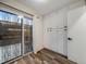 Bedroom featuring a sliding glass door to the outside, built-in cabinets, and wood floors at 1103 S Monaco Pkwy, Denver, CO 80224