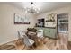 Modern dining room featuring an artistic light fixture and a clear glass dining table, offering a blend of style and comfort at 1103 S Monaco Pkwy, Denver, CO 80224