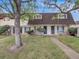 Charming townhome features a brick facade, trimmed shrubs, and a manicured lawn, creating inviting curb appeal at 1103 S Monaco Pkwy, Denver, CO 80224