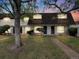 Charming townhome features a brick facade, trimmed shrubs, and a manicured lawn, creating inviting curb appeal at 1103 S Monaco Pkwy, Denver, CO 80224