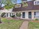 Townhome boasts a brick facade, security doors and trimmed bushes, creating curb appeal and a secure entrance at 1103 S Monaco Pkwy, Denver, CO 80224